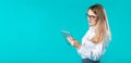 Portrait young caucasian woman worker teacher trainer mentoring in white shirt office style long hair with a tablet in hand uses Royalty Free Stock Photo