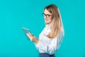 Portrait young caucasian woman worker teacher trainer mentoring in white shirt office style long hair with a tablet in hand uses Royalty Free Stock Photo