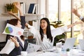 portrait of young cheerful Asian women office workers celebrating smiling happily by throwing paperwork to the air in a meeting Royalty Free Stock Photo