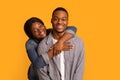 Portrait of young cheerful black couple hugging and smiling at camera Royalty Free Stock Photo