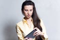 Portrait of young cheerful girl playing video games on smartphone over white background. Royalty Free Stock Photo