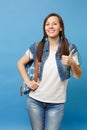 Portrait of young cheerful pretty happy woman student in white t-shirt, denim clothes with backpack showing thumb up Royalty Free Stock Photo