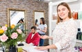 Portrait of young woman administrator inviting to beauty salon