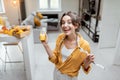 Portrait of a woman with juice and measuring tape at home Royalty Free Stock Photo