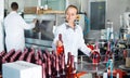 Woman working on wine production on manufactory