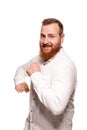 Portrait of a young, chubby, redheaded man in a white shirt making faces at the camera, isolated on a white background Royalty Free Stock Photo