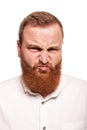 Portrait of a young, chubby, redheaded man in a white shirt making faces at the camera, isolated on a white background Royalty Free Stock Photo