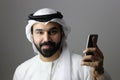 Portrait Of A Young Confident Arab Businessman Wearing UAE Emirati Tradational Dress Royalty Free Stock Photo