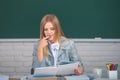 Portrait of a young, confident and attractive female student studying in school classroom. Female student reading book Royalty Free Stock Photo