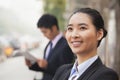 Portrait of young, confident businesswoman looking away and smiling in the street, Beijing, China Royalty Free Stock Photo