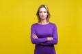 Portrait of young confident businesswoman standing with crossed hands. isolated on yellow background Royalty Free Stock Photo