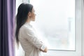 Portrait of young confident businesswoman in white shirt with arms crossed, woman looking out the window, office in skyscraper Royalty Free Stock Photo