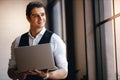 Portrait of a Young Confident CEO or Leader Working on Computer Laptop in the Modern Workplace. Smiling Businessman Royalty Free Stock Photo