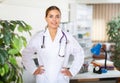 Portrait of a young female doctor standing in a resident's office Royalty Free Stock Photo