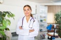 Portrait of a young female doctor standing in a resident's office Royalty Free Stock Photo