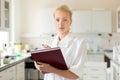 Portrait of young, confident female health care professional taking notes during inventory in scientific laboratory or Royalty Free Stock Photo