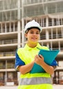 Portrait of a young confident female process engineer writing work notes