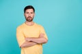 Portrait of young confident guy in yellow t shirt folded hands seems like experienced ceo product owner isolated on cyan