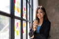 Portrait young confident smiling Asian business woman leader, successful entrepreneur, wearing suit standing in office Royalty Free Stock Photo