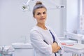Portrait of young confident smiling dentist doctor woman, female with arms crossed Royalty Free Stock Photo