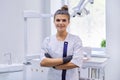 Portrait of young confident smiling dentist doctor woman, female with arms crossed Royalty Free Stock Photo