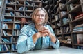 Portrait young confident bearded student blogger at library desk look at camera Royalty Free Stock Photo