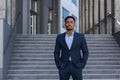 Portrait young confident successful African American businessman looking at camera Serious business man standing on urban Royalty Free Stock Photo