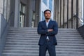 Portrait young confident successful African American businessman looking at camera Serious business man standing on urban Royalty Free Stock Photo