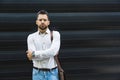 Portrait of young confident successful business man standing outside office building. Educated independent male team leader Royalty Free Stock Photo