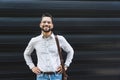 Portrait of young confident successful business man standing outside office building. Educated independent male team leader Royalty Free Stock Photo