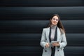 Portrait of young confident successful business woman standing outside office building. Educated independent female team leader Royalty Free Stock Photo