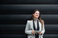 Portrait of young confident successful business woman standing outside office building. Educated independent female team leader Royalty Free Stock Photo