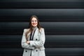 Portrait of young confident successful business woman standing outside office building. Educated independent female team leader Royalty Free Stock Photo