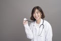 Portrait of young confident woman doctor isolated over grey background studio Royalty Free Stock Photo