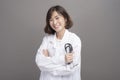 Portrait of young confident woman doctor isolated over grey background studio Royalty Free Stock Photo