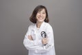 Portrait of young confident woman doctor isolated over grey background studio Royalty Free Stock Photo