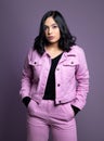 Portrait of Young Confident Women in pink Violet background In studio