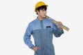 Portrait of young construction worker wearing yellow helmet in a Uniform mechanic is holding level Royalty Free Stock Photo