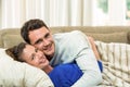 Portrait of young couple cuddling on sofa
