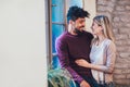 Portrait of a young couple hugging next to the window Royalty Free Stock Photo