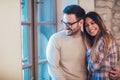 Portrait of a young couple hugging next to the window Royalty Free Stock Photo