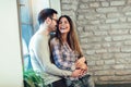 Portrait of a young couple hugging next to the window Royalty Free Stock Photo