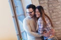 Portrait of a young couple hugging next to the window Royalty Free Stock Photo
