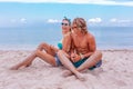 Portrait of young couple in love at beach and enjoying time being together. Young couple having fun on a sandy coast. Royalty Free Stock Photo