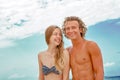 Portrait of young couple in love at beach and enjoying time being together. Young couple having fun on a sandy coast. Royalty Free Stock Photo