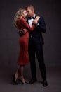 Portrait of young couple in love posing at studio dressed in classic clothes Royalty Free Stock Photo