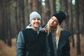 Portrait of young couple in love walking in beautiful forest enjoying hugging and smiling.