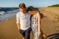 Portrait Of Young Couple In Love Walking On Sandy Beach
