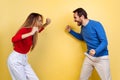 Portrait of young couple, man and woman, feeling and expressing extreme excitement and happiness isolated over yellow