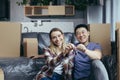 Portrait of a young couple man and woman looking at the camera and smiling holding the keys to a new apartment, multiracial family Royalty Free Stock Photo